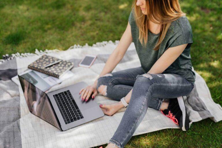 Girl working on a laptop in park