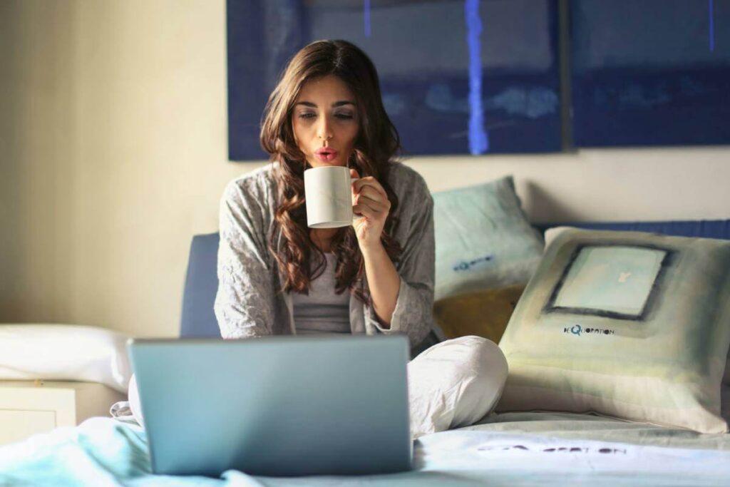 girl working on a laptop while having coffee