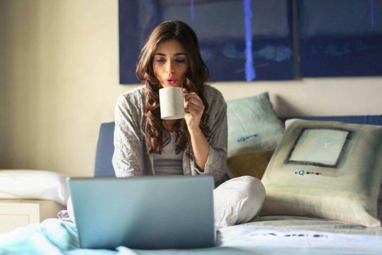 girl working on a laptop while having coffee