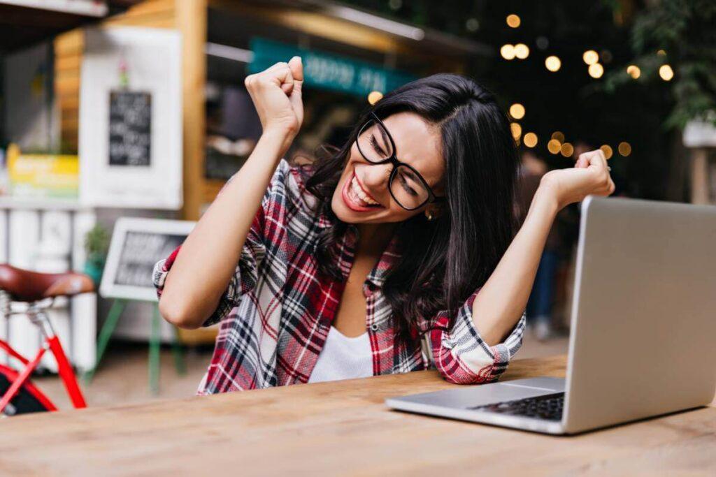 Happy girl overjoyed with a laptop