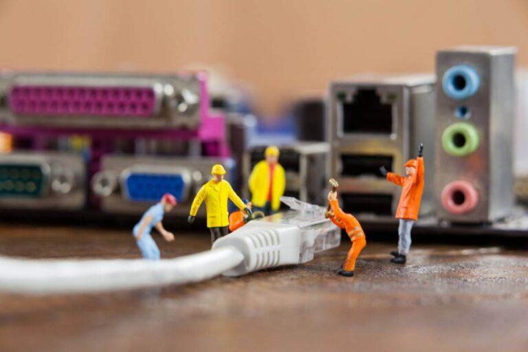 miniature field technicians fixing cable