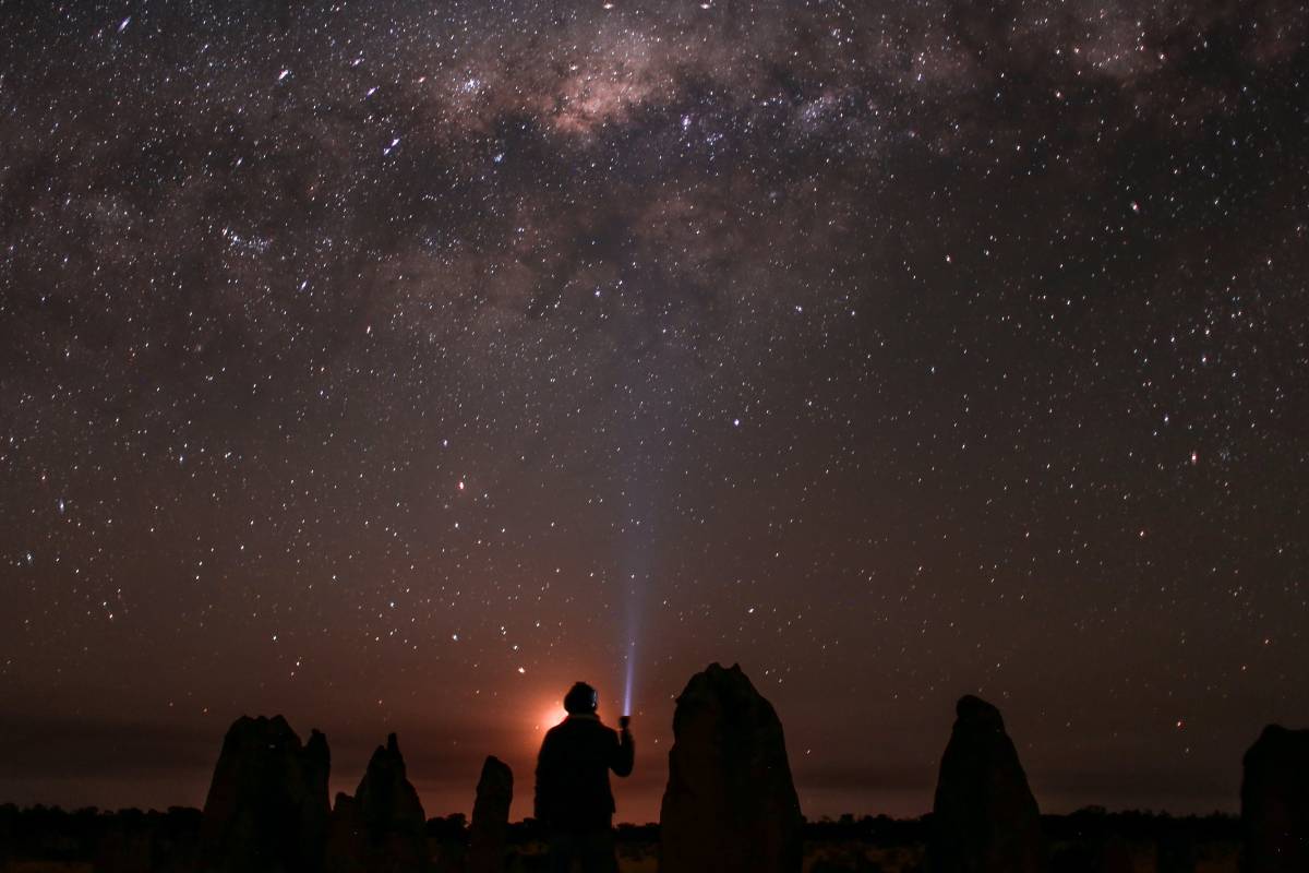 Person stargazing in the clear sky