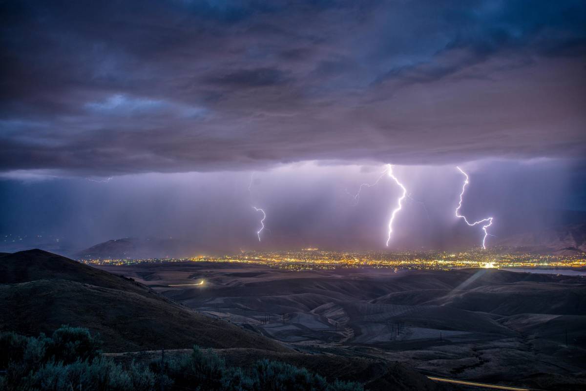 lightning strikes over a city